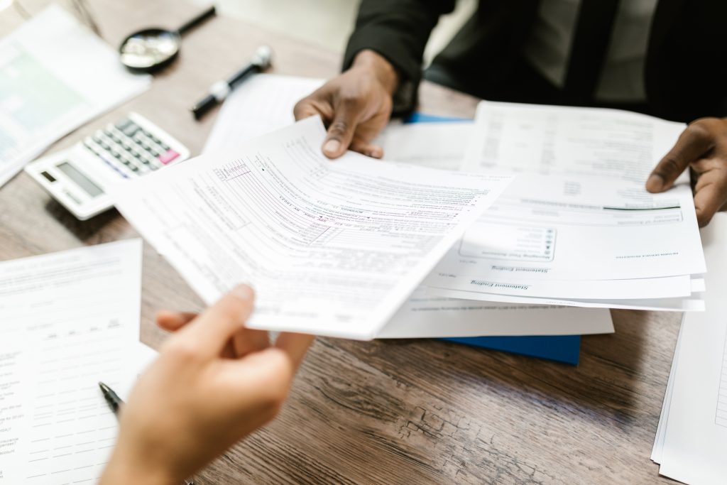 accountant handing out papers to her client