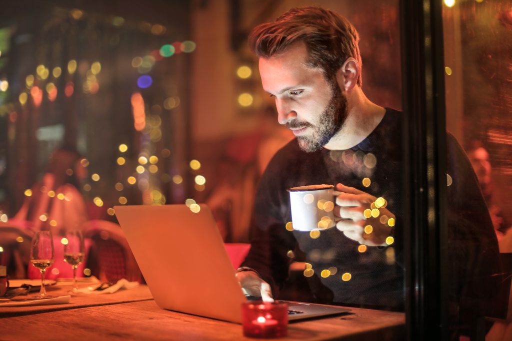 accountant working on a laptop with red background lights