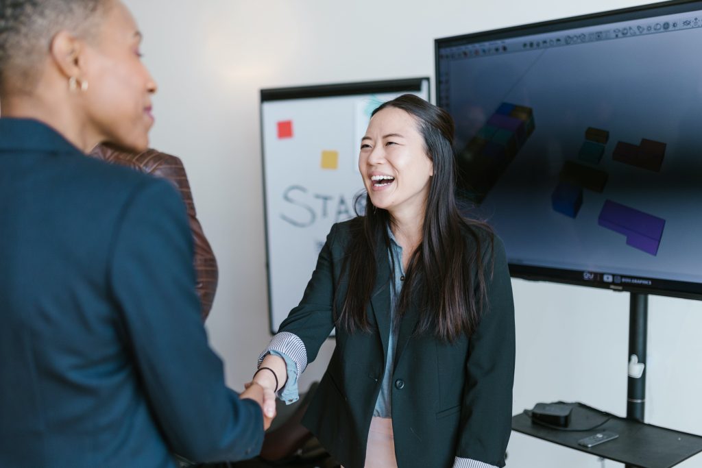 accountant shaking hands with her client after a pitch