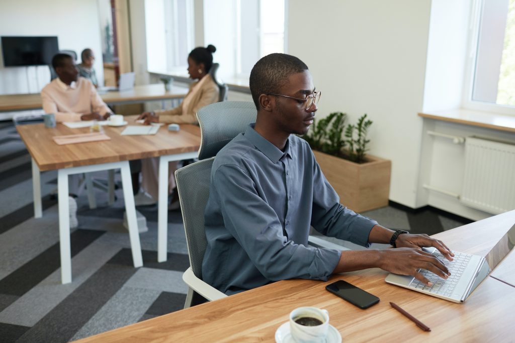 accountant in polo along with coffee and mobile phone