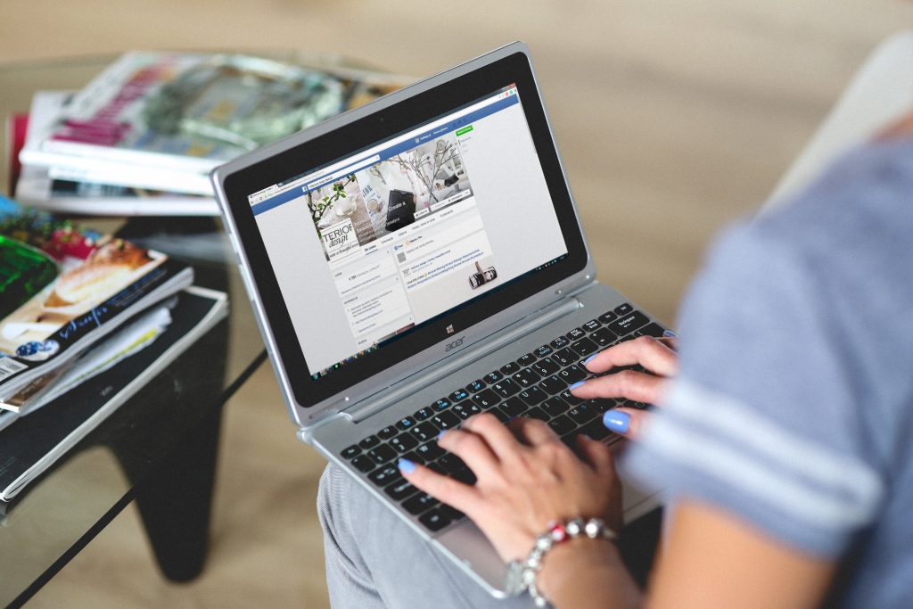 accountant checking a social media profile on her laptop