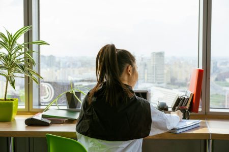 accountant working on an office with the view of a city on the background