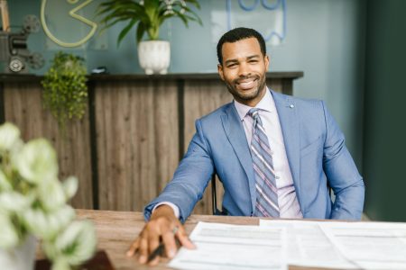 smiling accountant with reports on the top of his table